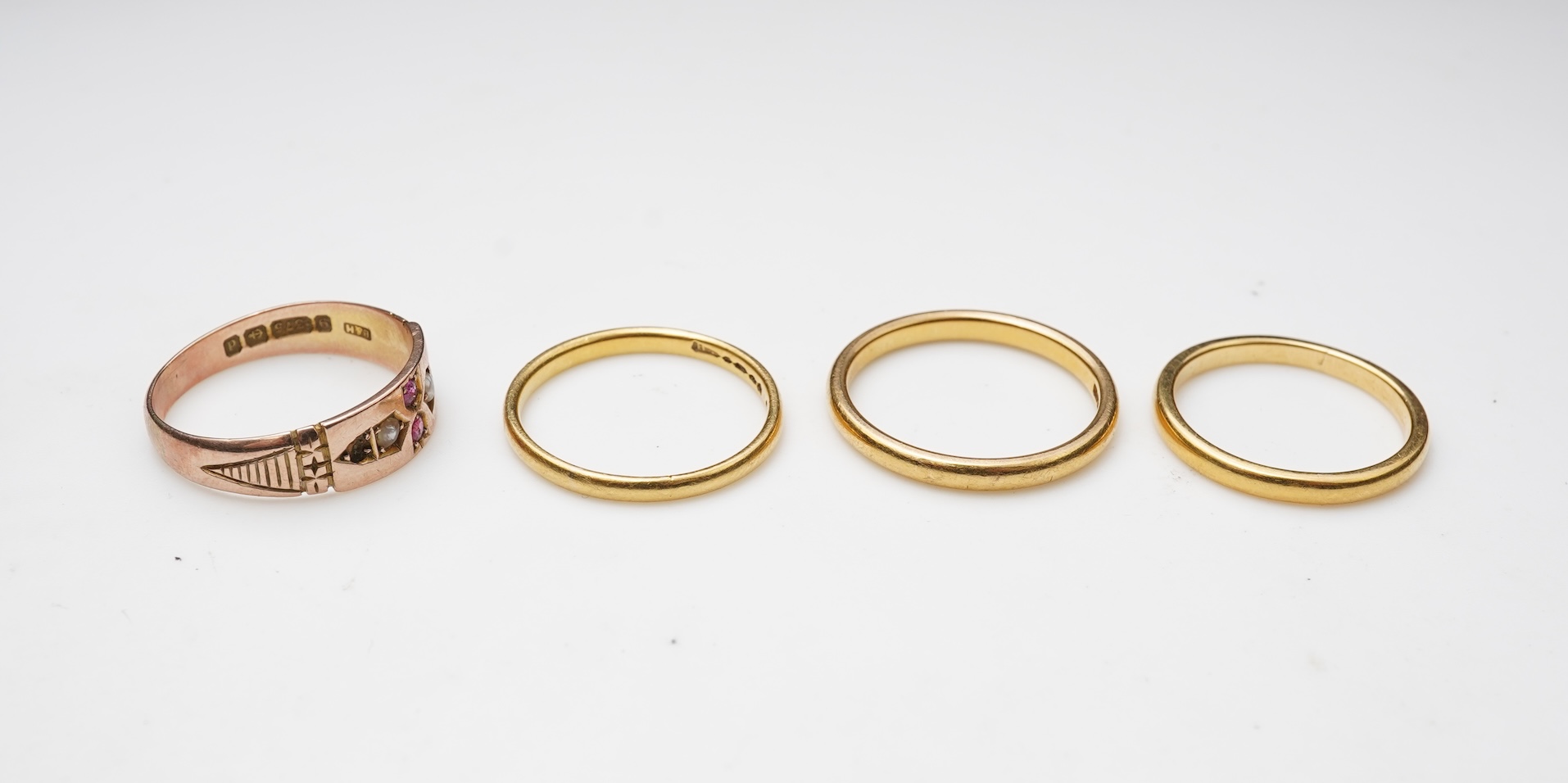 A collection of four gold rings